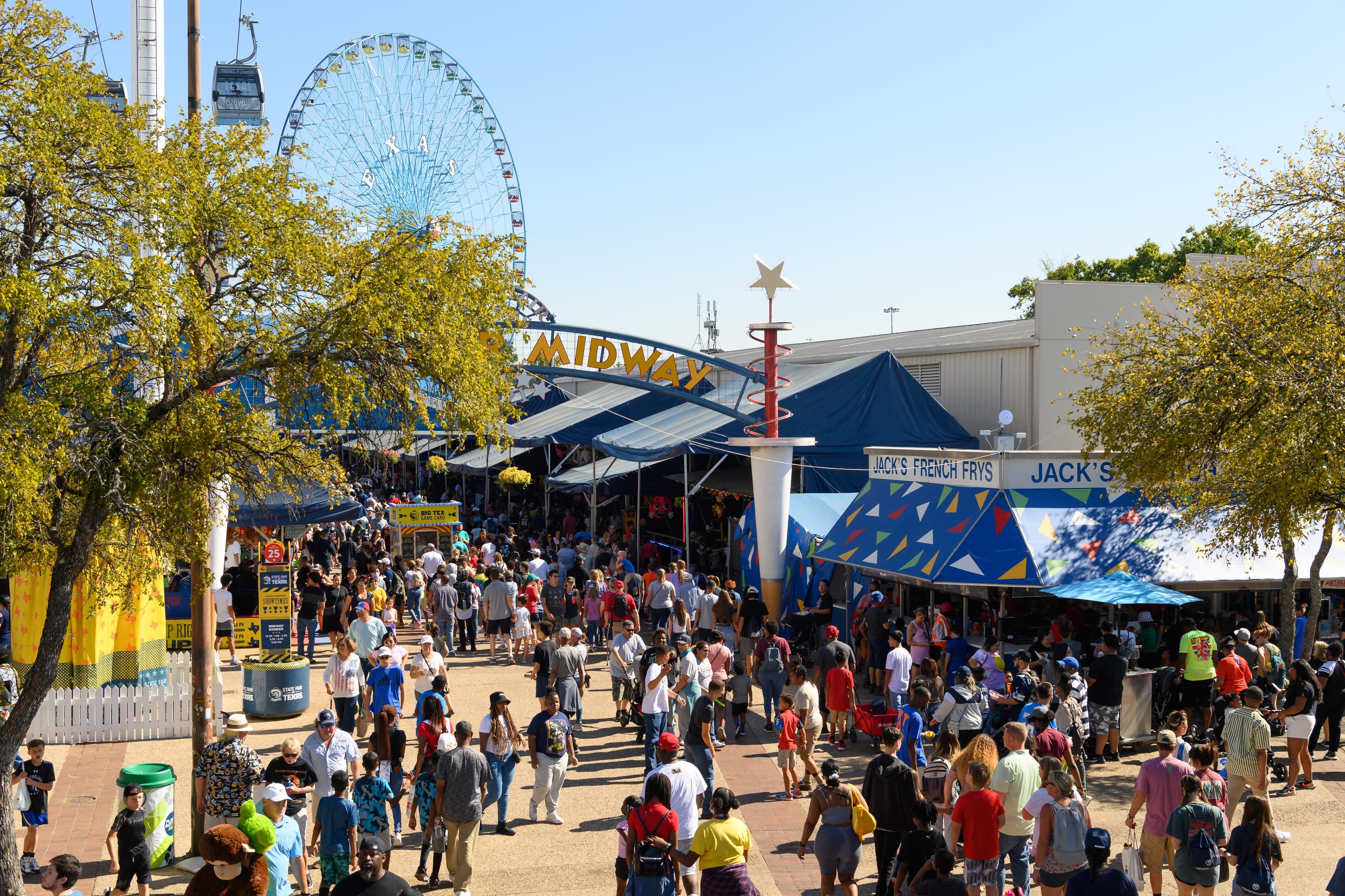 File photo: Fairgoers walk past Midway games and attractions.
